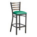 A Lancaster Table & Seating black metal ladder back bar stool with green vinyl padded seat.