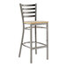 A Lancaster Table & Seating clear coated metal bar stool with a driftwood seat.