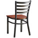 A Lancaster Table & Seating metal chair with a wood seat and back.