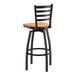A black metal swivel bar stool with a ladder back design and a cherry wood seat.