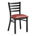 A Lancaster Table & Seating black metal ladder back chair with a burgundy vinyl cushion.