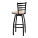 A black metal ladder back swivel bar stool with a light driftwood seat.