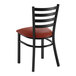 A black metal ladder back chair with a burgundy vinyl padded seat.