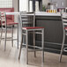 Lancaster Table & Seating ladder back bar stools with mahogany seats at a counter.
