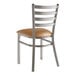 A Lancaster Table & Seating metal ladder back chair with a light brown vinyl padded seat.