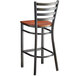 A Lancaster Table & Seating distressed copper finish ladder back bar stool with a wooden seat.