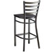 A black Lancaster Table & Seating ladder back bar stool with a black wood seat.