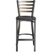 A Lancaster Table & Seating black metal ladder back bar stool with a black wood seat.