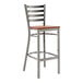 A Lancaster Table & Seating metal bar stool with a wooden seat.