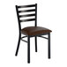 A metal ladder back chair with a distressed copper finish and a dark brown vinyl padded seat.
