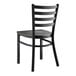 A black Lancaster Table & Seating metal chair with a wooden seat and back.