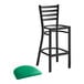 A Lancaster Table & Seating black ladder back bar stool with a green vinyl padded seat.