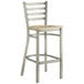 A Lancaster Table & Seating metal bar stool with a driftwood seat.