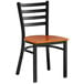 A black Lancaster Table & Seating ladder back chair with a cherry wood seat.