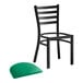 A Lancaster Table & Seating black ladder back chair with a green vinyl padded seat.