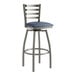 A Lancaster Table & Seating bar stool with navy vinyl cushion and ladder back.