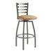 A Lancaster Table & Seating swivel bar stool with light brown vinyl padding on the seat and back.