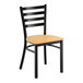 A ladder back chair with a distressed copper finish and a natural wood seat.