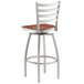 A Lancaster Table & Seating swivel bar stool with a wooden seat.