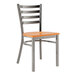 A Lancaster Table & Seating metal ladder back chair with a wooden seat.