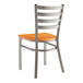 A Lancaster Table & Seating metal ladder back chair with a wooden seat.