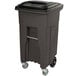 A brown Toter rectangular trash can with wheels.