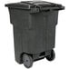 A black Toter rectangular trash can with wheels.