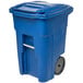 A blue Toter trash can with wheels.