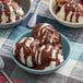 A bowl of ice cream with HEATH Chocolate Toffee Shell Topping.