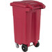 a red plastic trash can