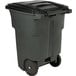 A black Toter rectangular trash can with wheels.