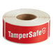 A roll of red TamperSafe labels with white text.