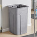 a grey plastic trash can