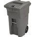 A grey Toter commercial trash can with wheels.