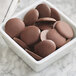 A bowl of chocolate cookies covered in Guittard Organic 66% Bittersweet Wafers.