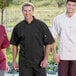 Three men wearing Uncommon Chef black chef coats.