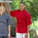 A man and woman wearing red Uncommon Chef short sleeve chef jackets.