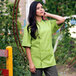 a woman wearing a green chef's uniform