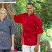 A man and woman wearing Uncommon Chef red short sleeve chef coats.