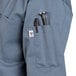 A steel blue short sleeve chef coat with a pocket.