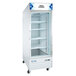 An Avantco white glass door freezer on wheels.