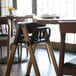 A Koala Stowe high chair with a black seat at a table.