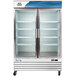An Avantco white swing glass door refrigerator with shelves.