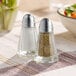 Two American Metalcraft salt and pepper shakers on a table.