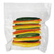 A plastic bag of yellow and green vegetables.