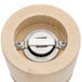 A close-up of the Chef Specialties Imperial Natural Finish Pepper Mill. A wooden cylinder with a circular metal object on the top.