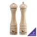 A Chef Specialties Imperial natural wood pepper mill and salt shaker on a counter.