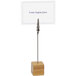 A Front of the House bamboo card holder with a paper on it on a table.