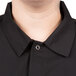 A person wearing a black Chef Revival cook shirt.