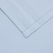 A light blue cloth table cover with a white hem.